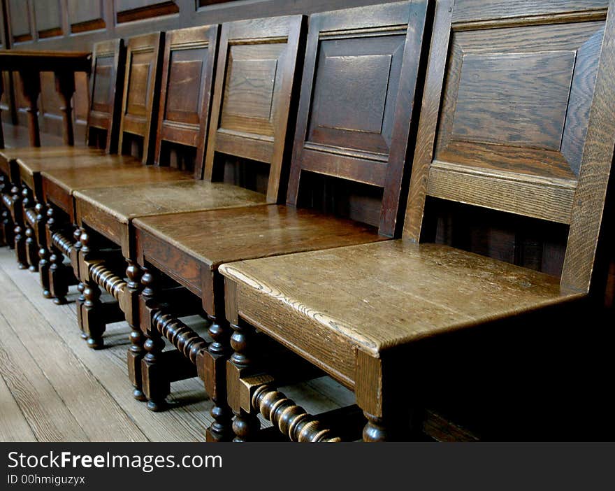 Neat old, antique church chairs in a row. Neat old, antique church chairs in a row.