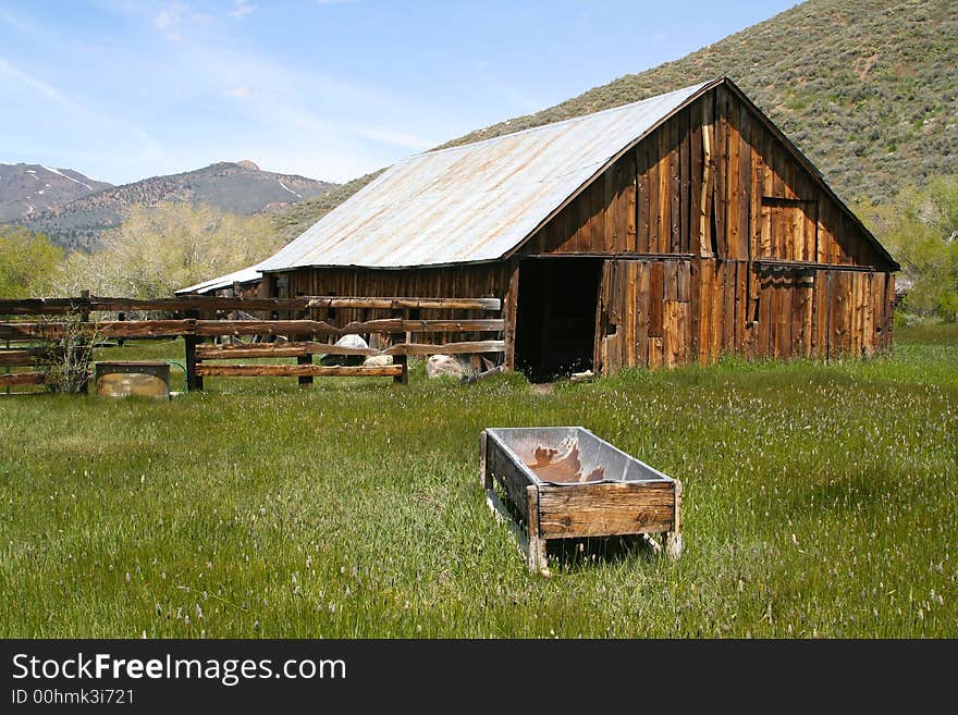 Taken in the Sierras - a rustic, old, abandoned barn. Rich with old wood and overgrown grass.