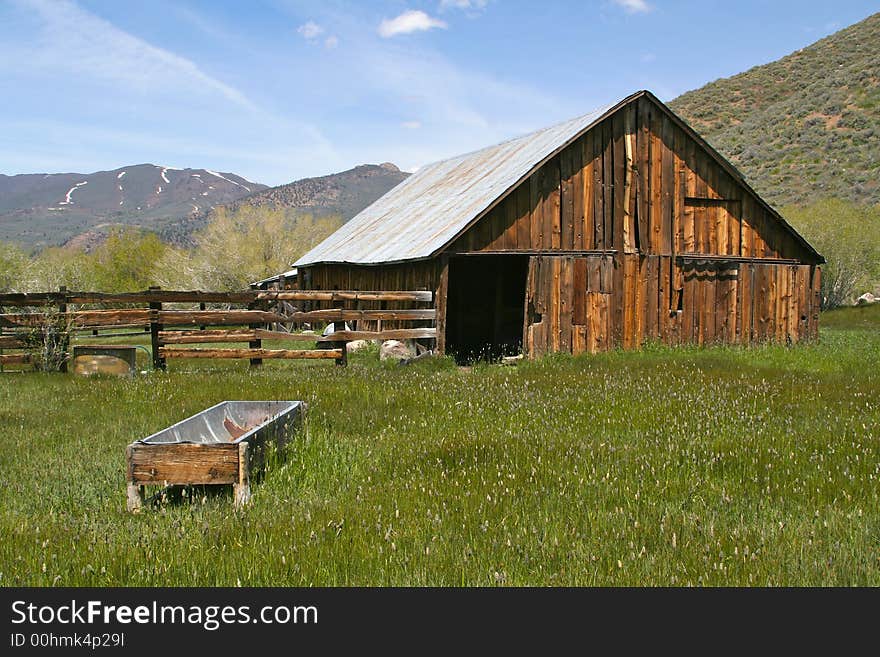 Taken in the Sierras - a rustic, old, abandoned barn. Rich with old wood and overgrown grass.