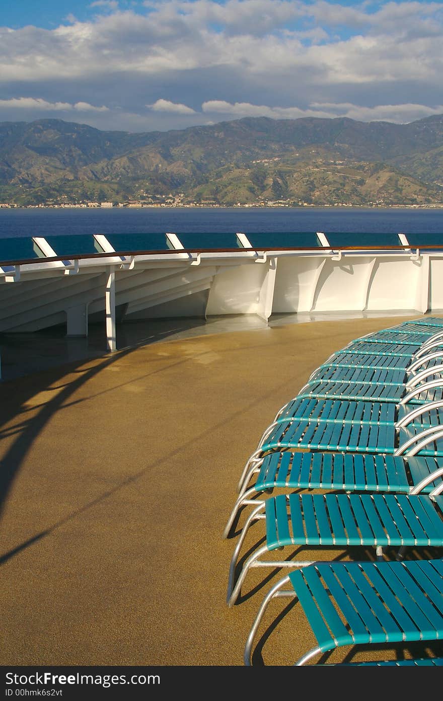 Cruise ship deck abstract shot with deck chairs. The deck is illuminated by the morning sun fresh from a wash down. Taken during a Day At. Cruise ship deck abstract shot with deck chairs. The deck is illuminated by the morning sun fresh from a wash down. Taken during a Day At