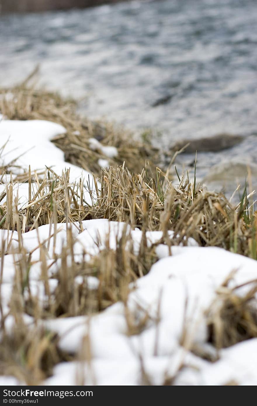 A river in the winter with the focus on the foreground. A river in the winter with the focus on the foreground