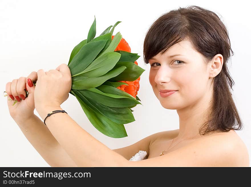 Beautiful white woman in a wedding dress isolated on a white background with flowers smiling