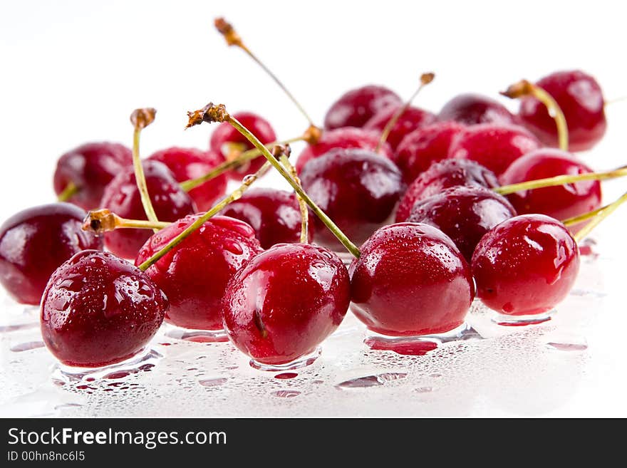 Cooled sweet cherries in drops of waters shined from below. Cooled sweet cherries in drops of waters shined from below