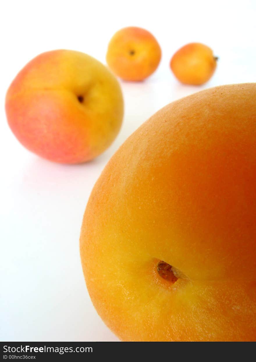 Four apricots on the table