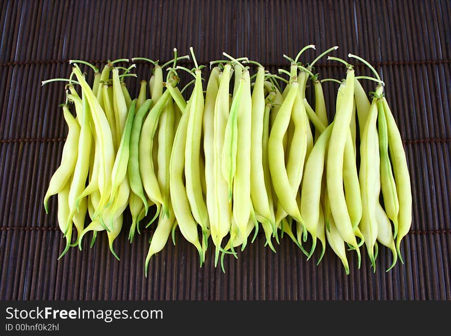 String yellow beans on a white background