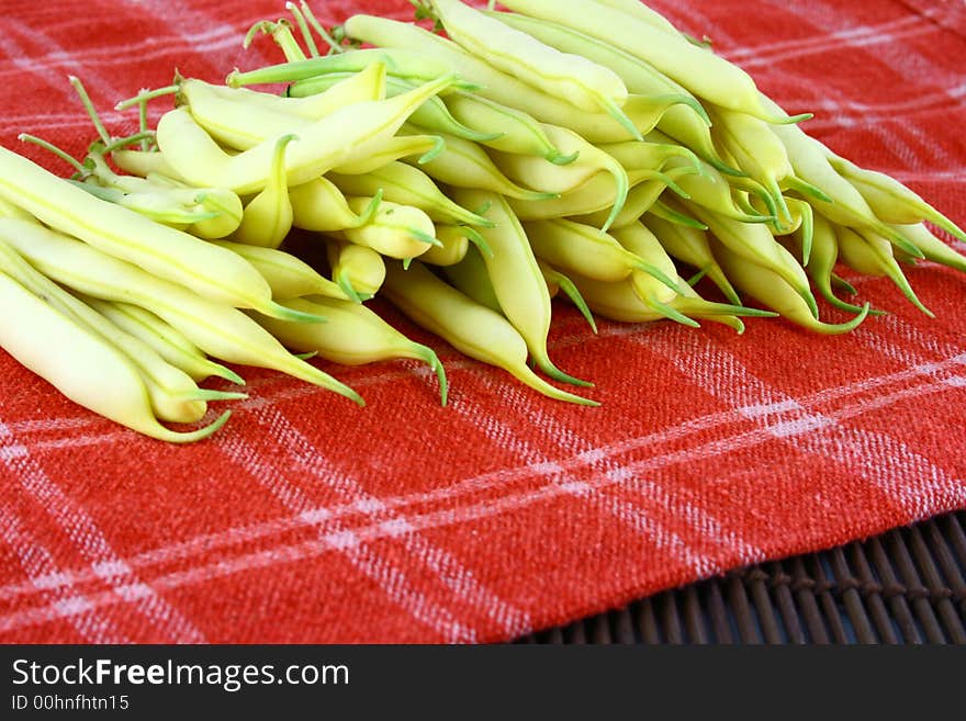 String yellow beans on a white background