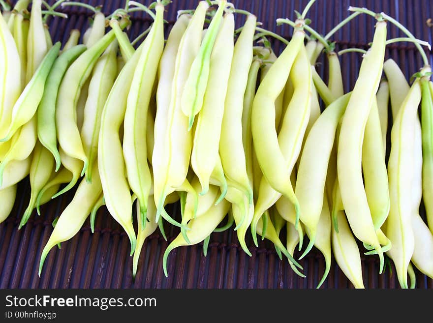 String yellow beans on a white background