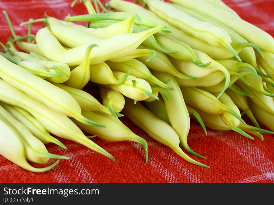 String yellow beans on a white background