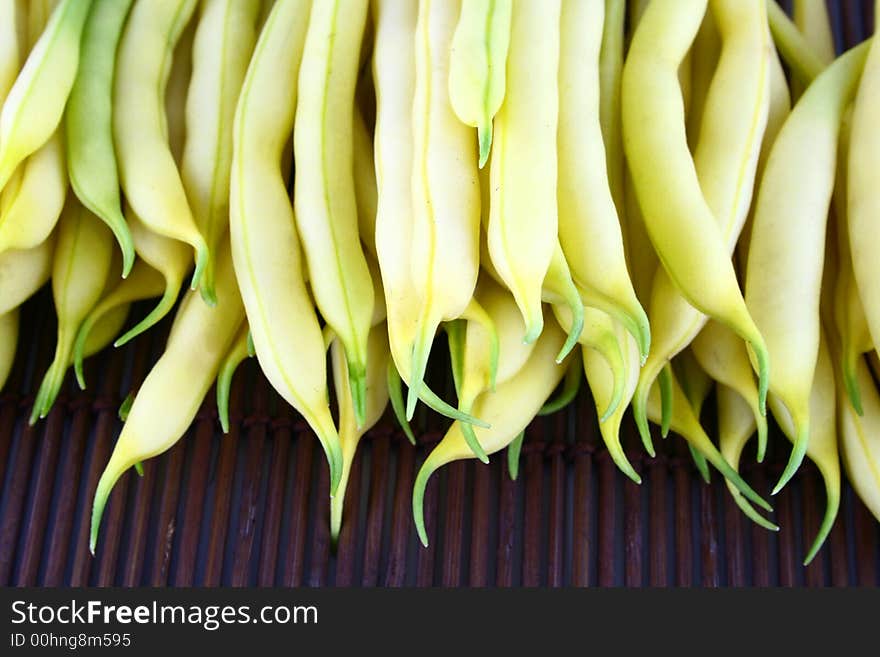 String yellow beans on a white background