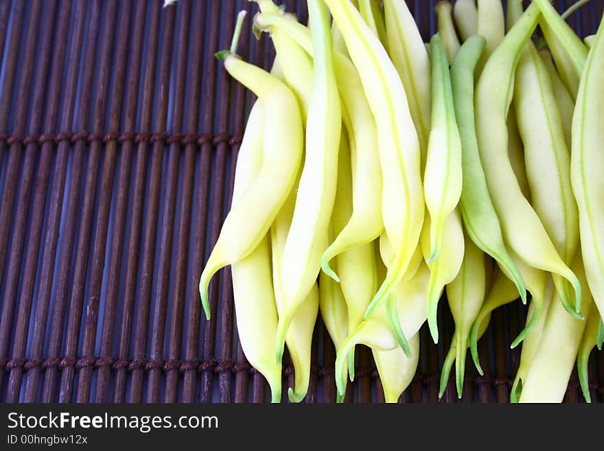 String yellow beans on a white background