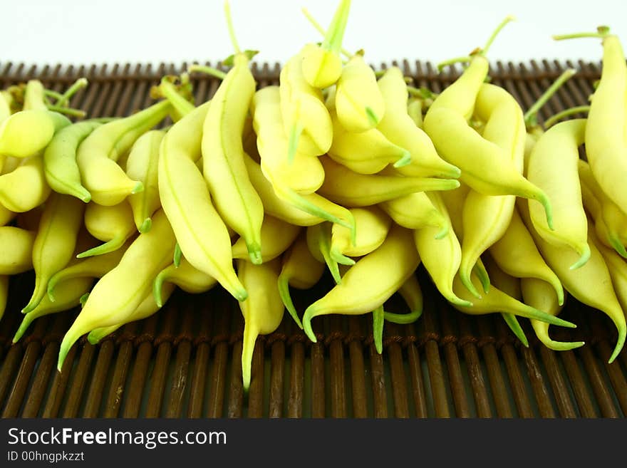 String yellow beans on a white background