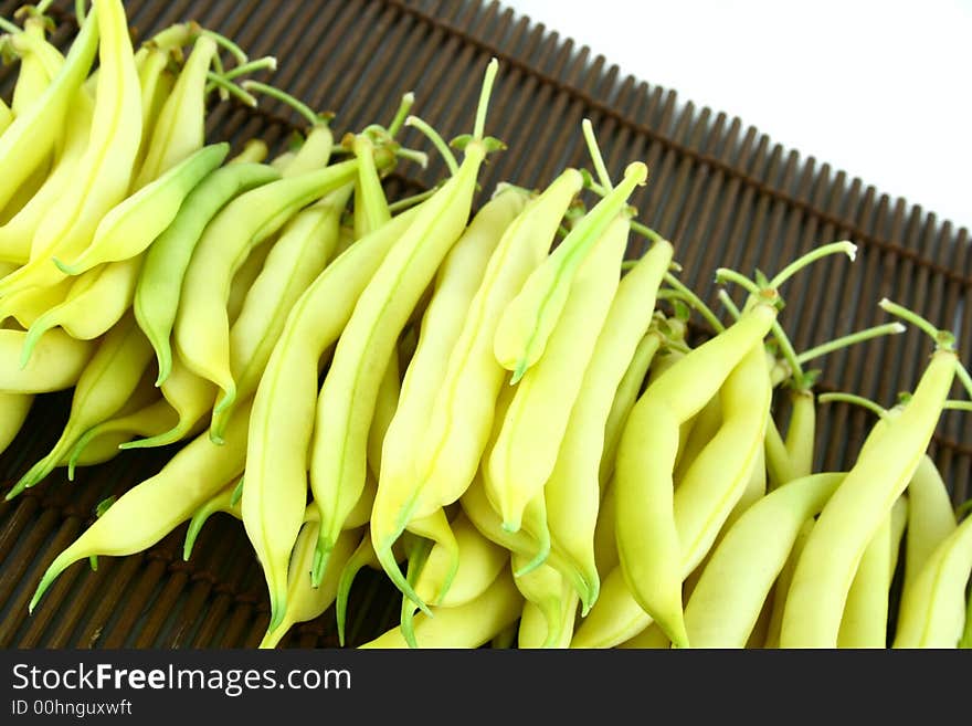 String yellow beans on a white background