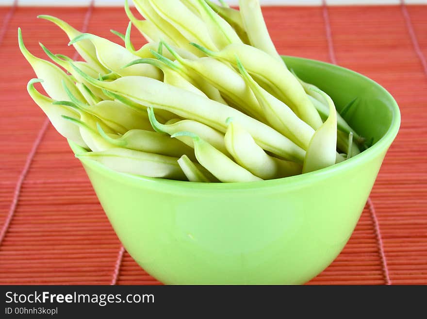 String yellow beans on a white background