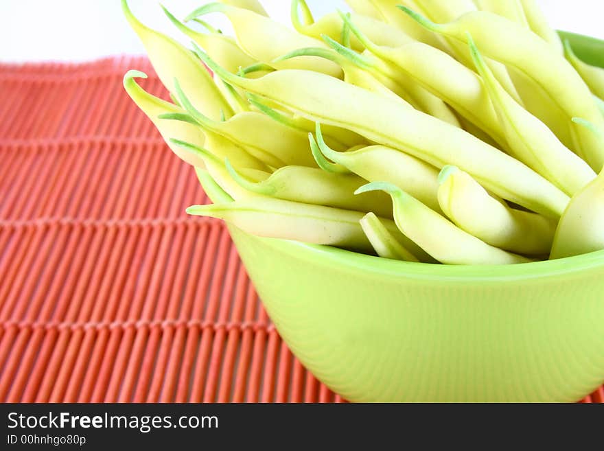 String yellow beans on a white background