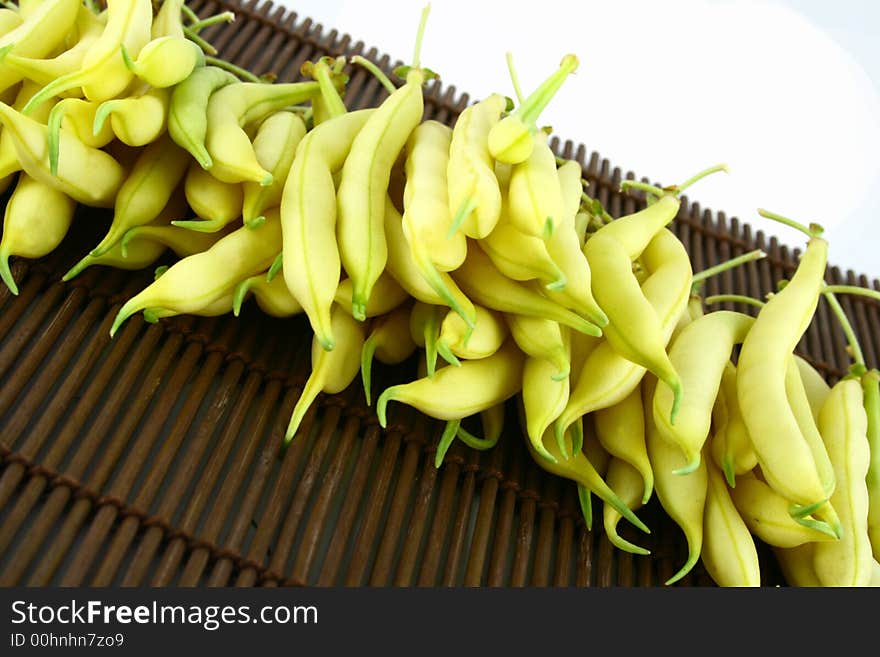 String yellow beans on a white background