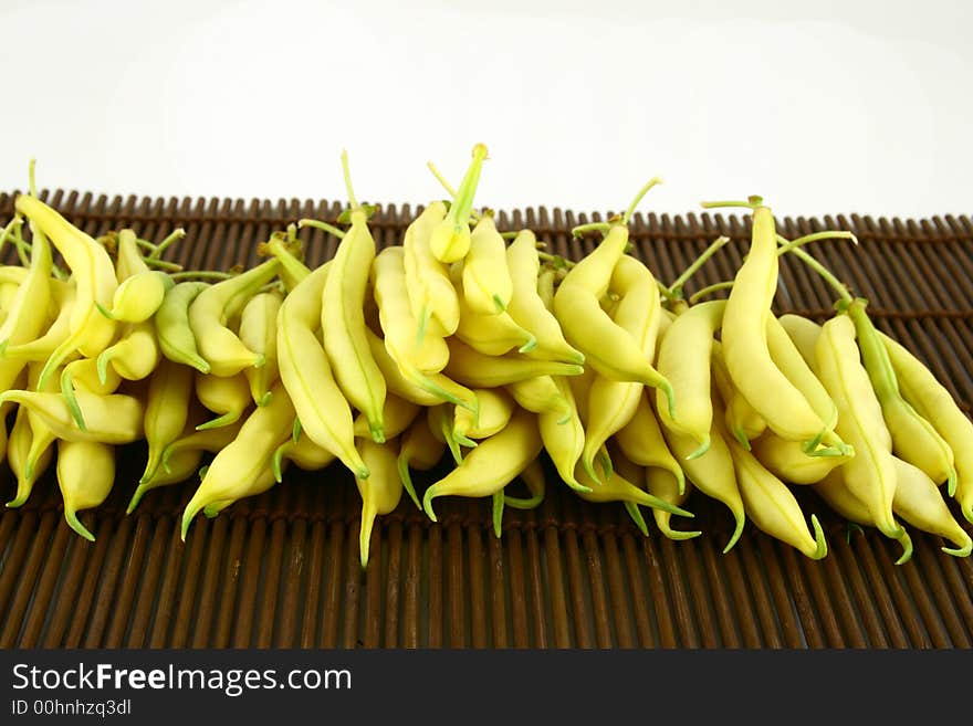 String yellow beans on a white background