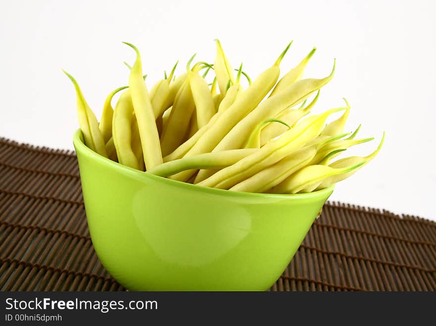 String yellow beans on a white background