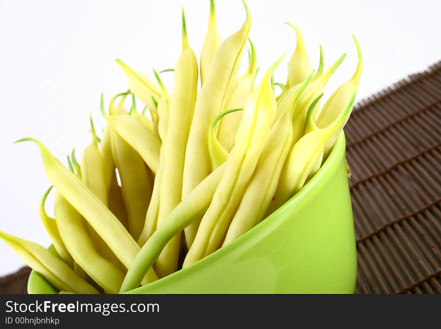 String yellow beans on a white background