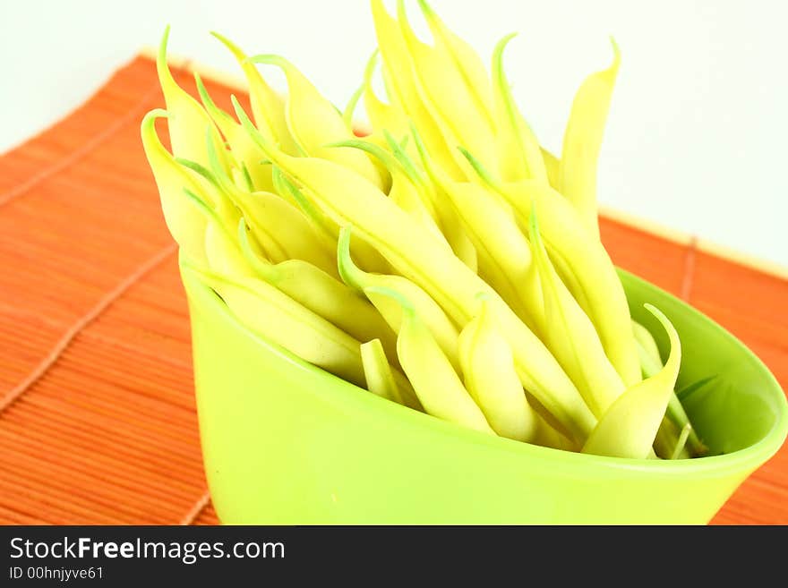 String yellow beans on a white background