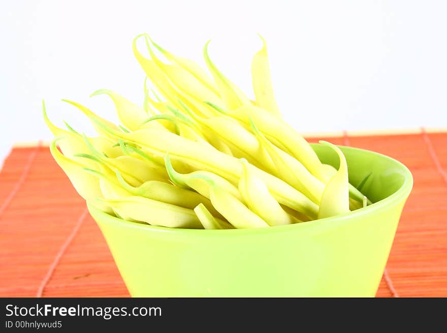 String yellow beans on a white background