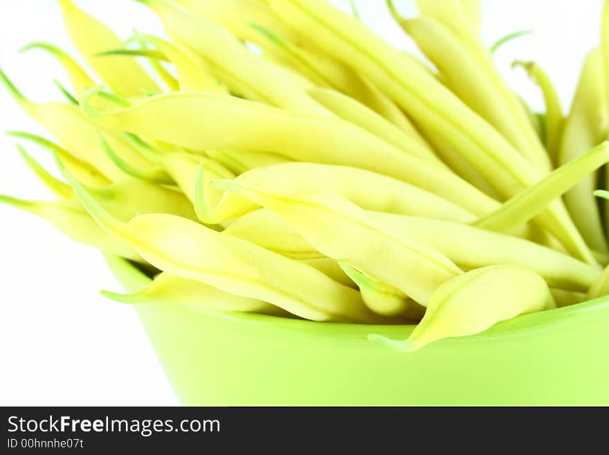 String yellow beans on a white background