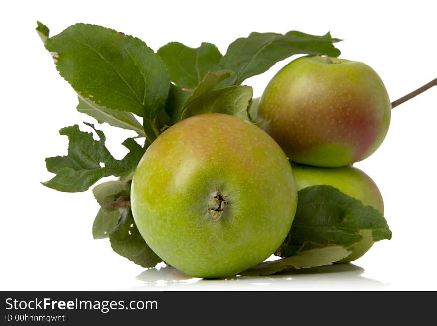 Green apples and leaves isolated over white background