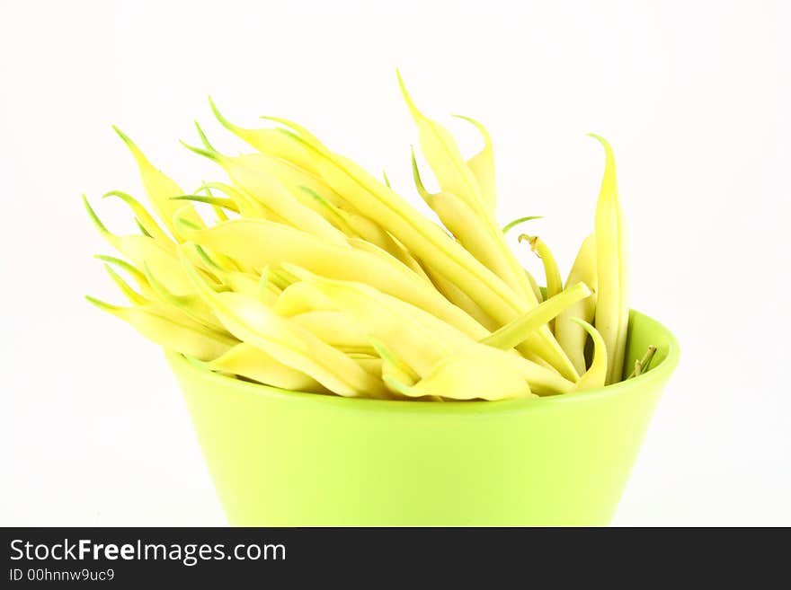 String yellow beans on a white background