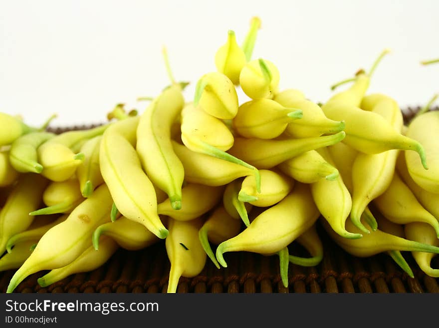 String yellow beans on a white background