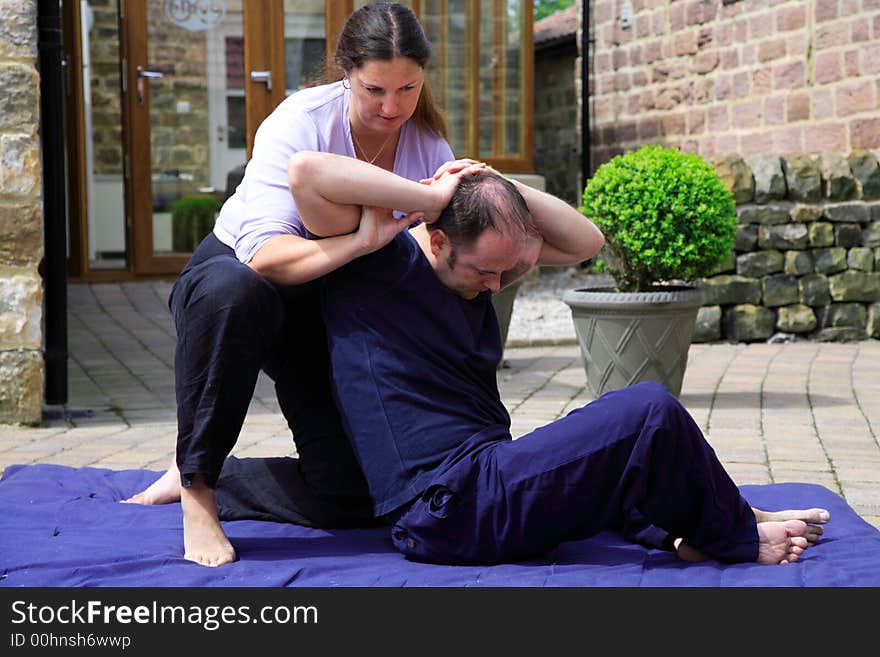 Twisting of the spine as part of a Thai body massage