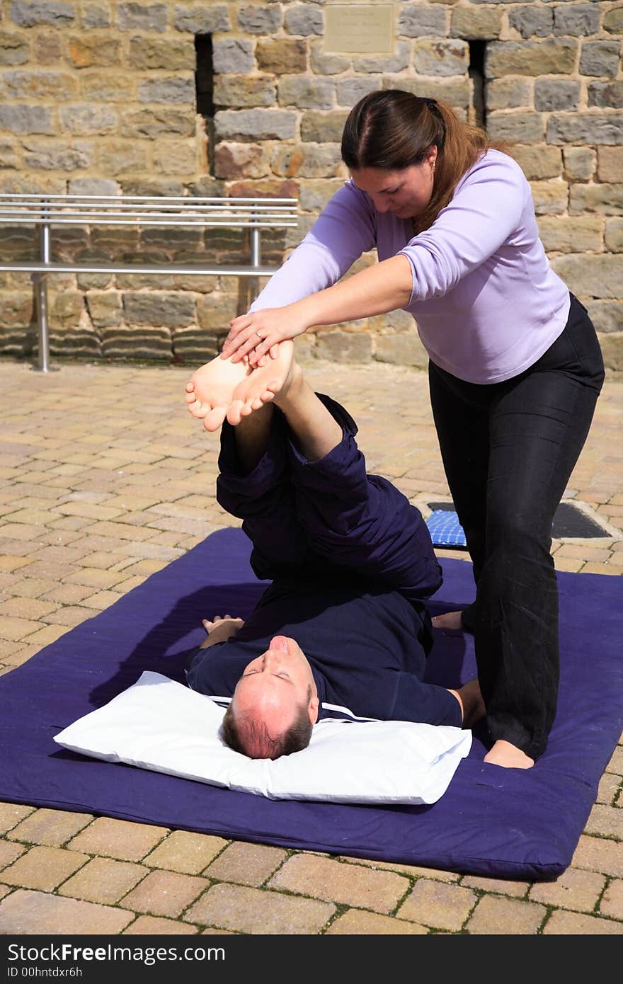 Leg and lower back stretch as part of a Thai massage