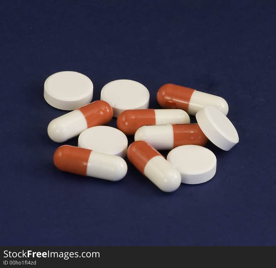 Assorted tablets on a blue background. Assorted tablets on a blue background