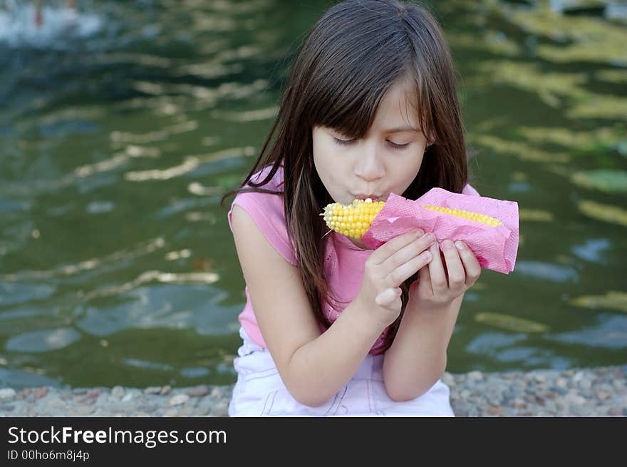 Girl eating corn