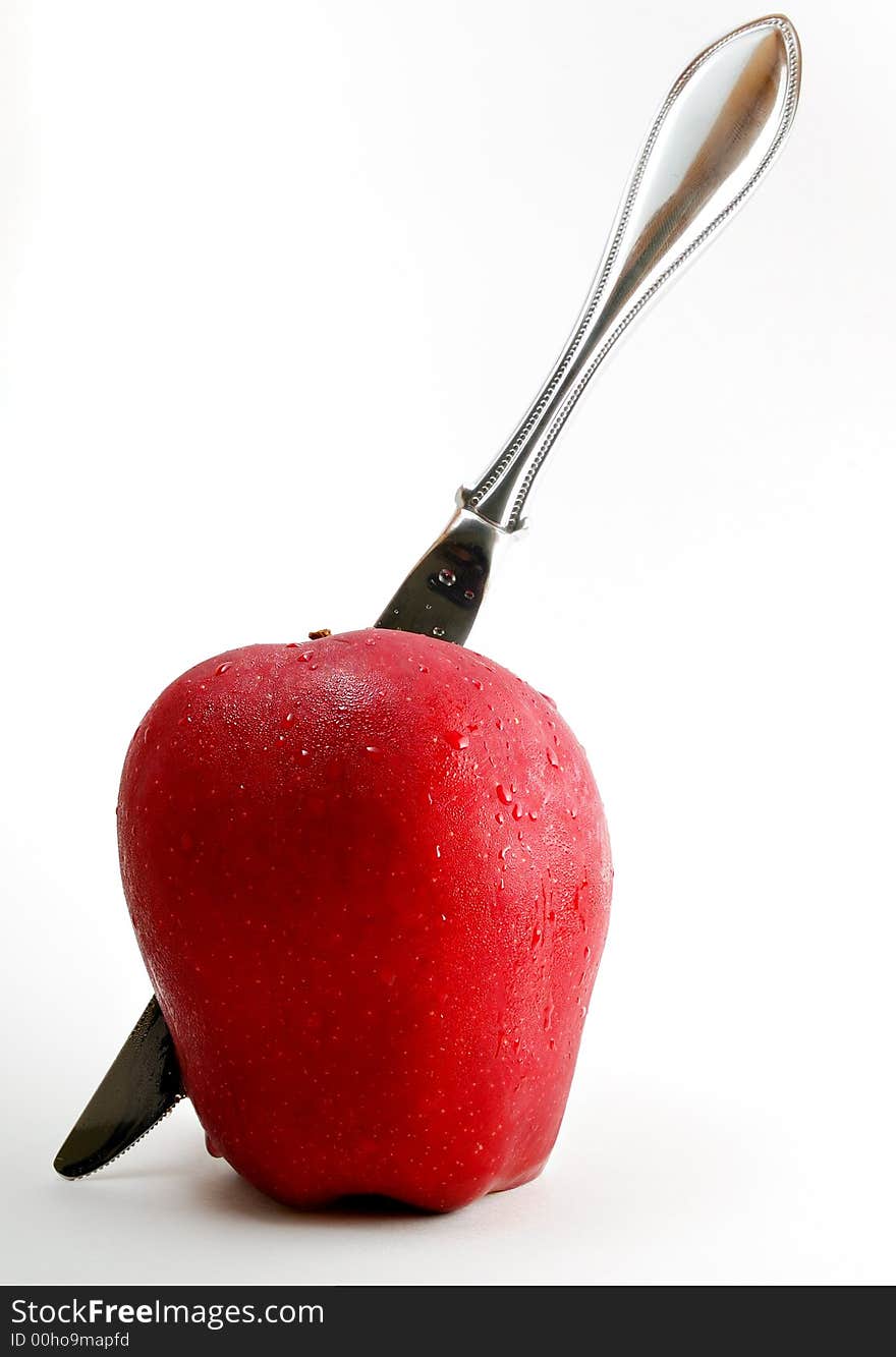 Sharp knife through a red apple. Sharp knife through a red apple