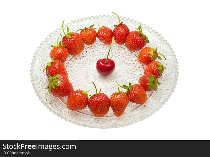 Strawberries and a cherry on a glass dish, isolated on white background. Strawberries and a cherry on a glass dish, isolated on white background