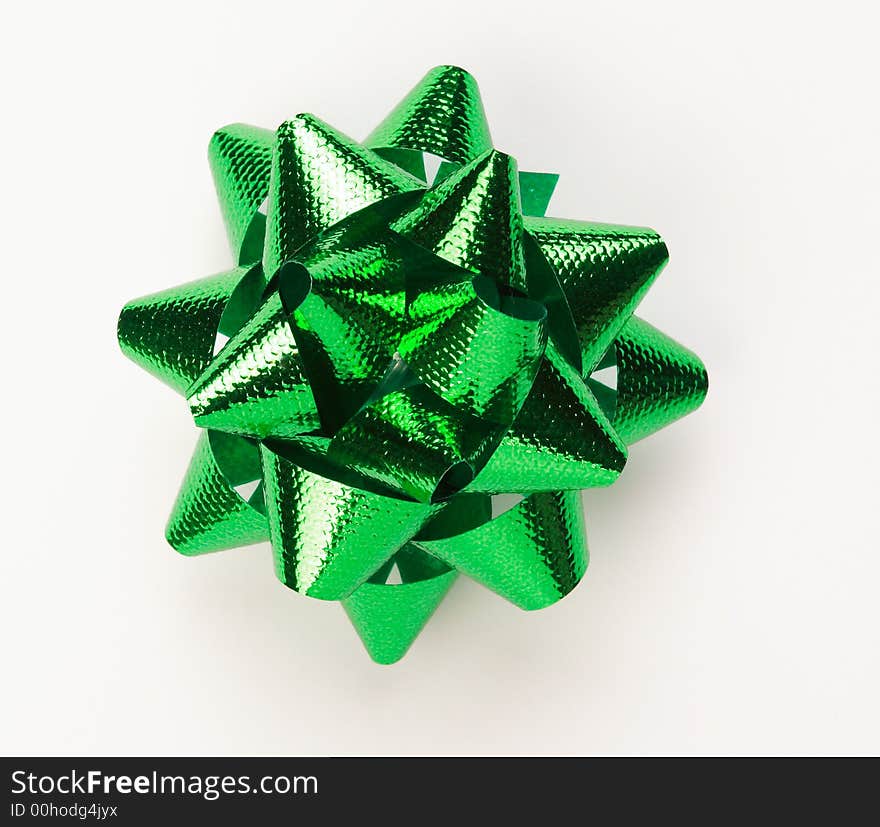 A green bow on a white surface. A green bow on a white surface