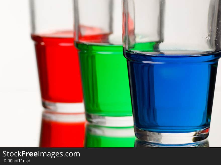 Red green blue coloured liquid in three glasses