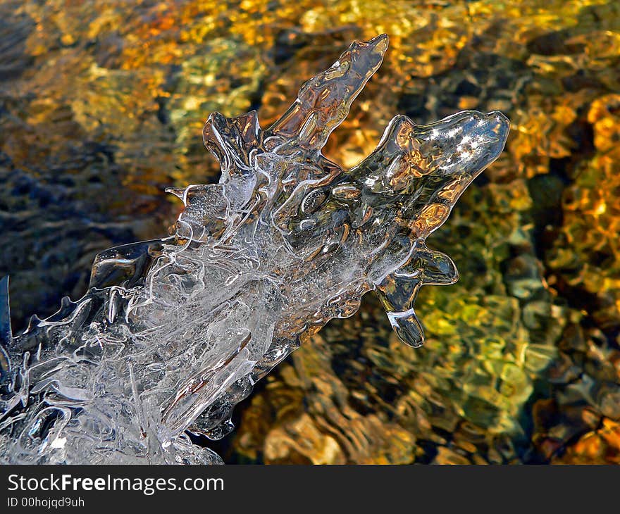 A close up of the fancy melting ice abobe the flowing water. A close up of the fancy melting ice abobe the flowing water.