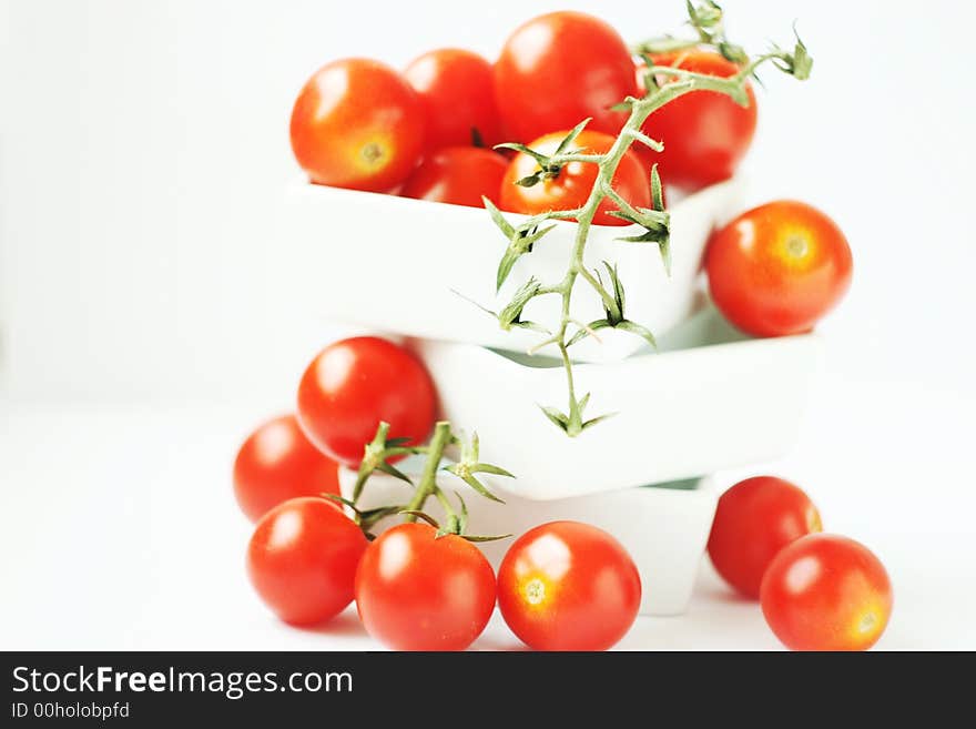 Fresh tomatoes in a square bowl on white background. Fresh tomatoes in a square bowl on white background