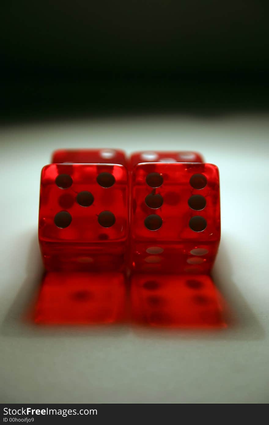 4 semi transparent dice with 5 & 6 facing the camera. 4 semi transparent dice with 5 & 6 facing the camera