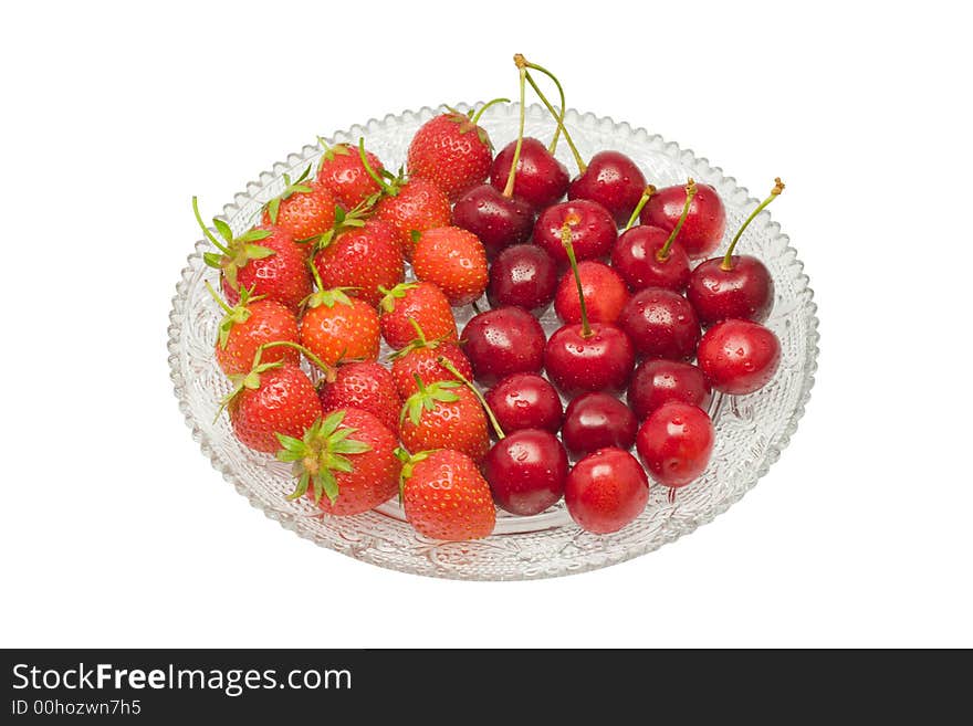 Strawberries and cherries on a glass dish, isolated on white background. Strawberries and cherries on a glass dish, isolated on white background