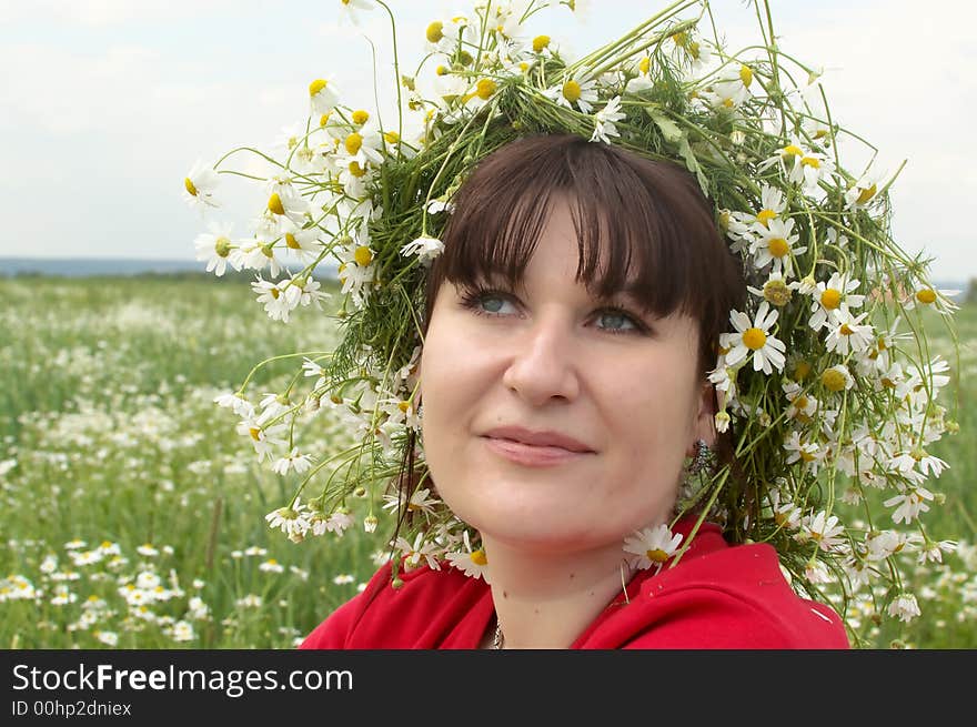 Portrait of young woman in a field of wild white daisies. Portrait of young woman in a field of wild white daisies