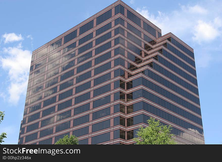 Brick and Glass Office Tower reflecting sky and clouds. Brick and Glass Office Tower reflecting sky and clouds