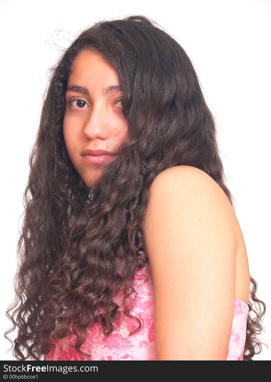 An portrait of a young teenager from the side and her
long curly hair hangs down, in a pink dress. On white background. An portrait of a young teenager from the side and her
long curly hair hangs down, in a pink dress. On white background.