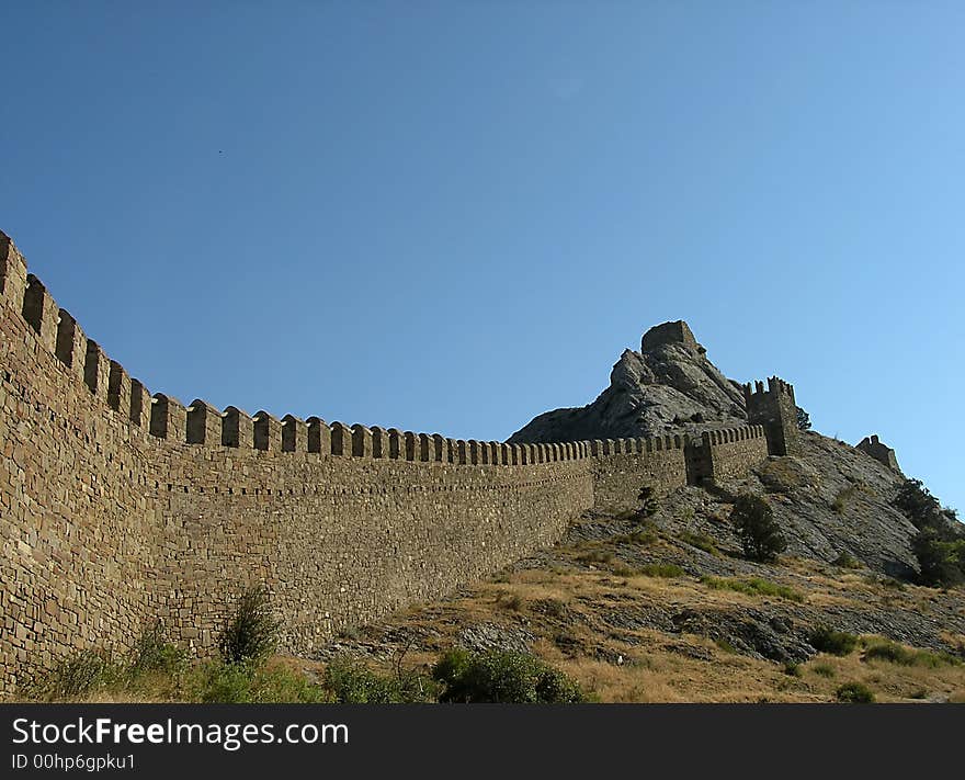 Big castle at the mountain against a sky background. Big castle at the mountain against a sky background