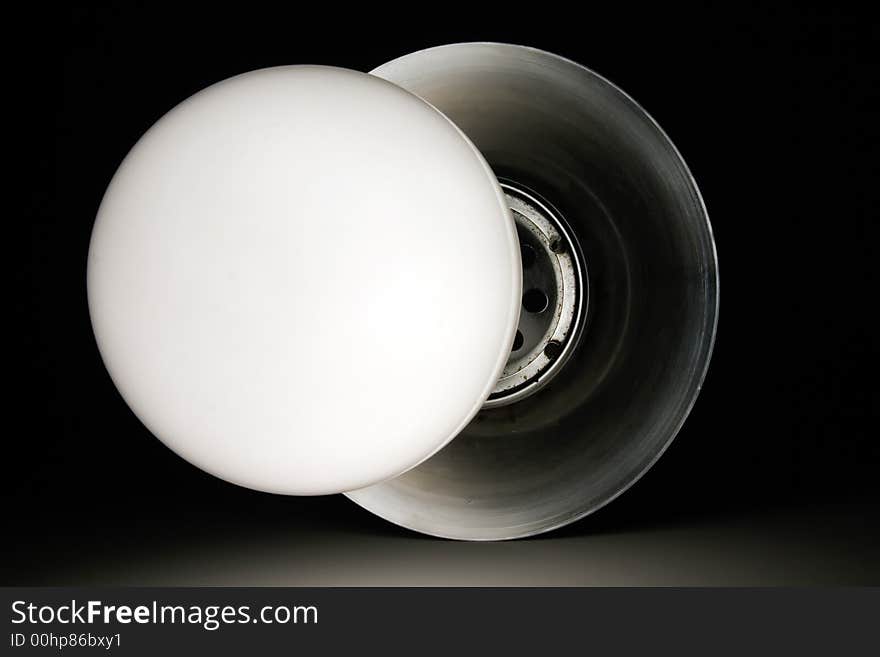 Glass circle light bulb on metal arm. Glass circle light bulb on metal arm