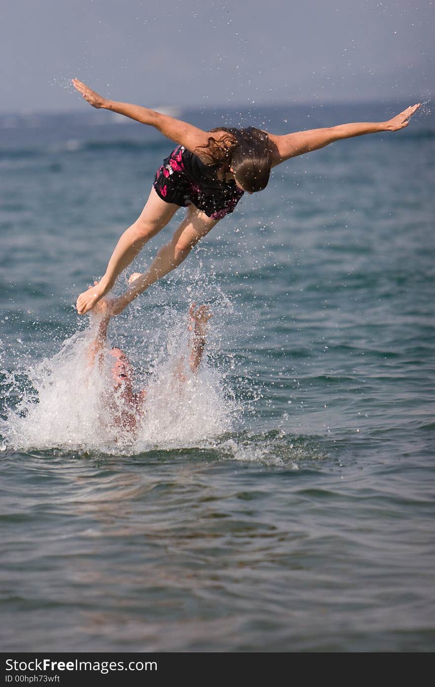 Woman being tossed out of the water. Woman being tossed out of the water.