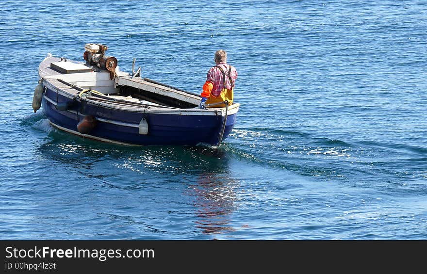 A fisherman going out on his small boat to lift the lobster/crab pots (creels). A fisherman going out on his small boat to lift the lobster/crab pots (creels).