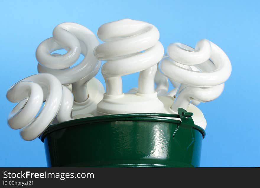 Electric bulbs on a bucket over blue background