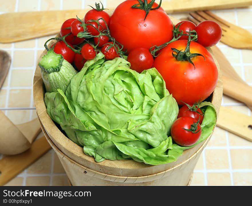 Diferents fresh vegetables on wooden basket with drops