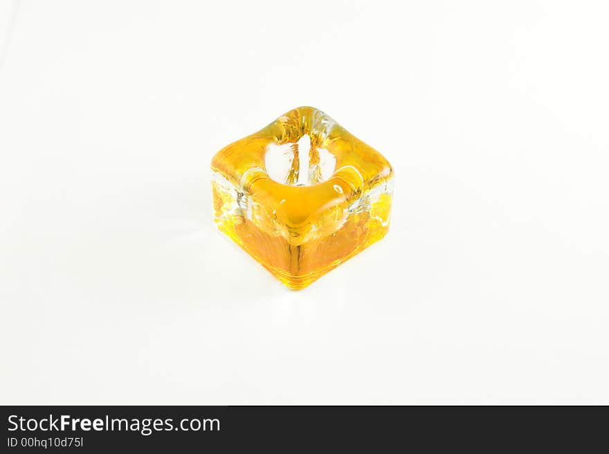 Yellow glazed candlestick on the white background